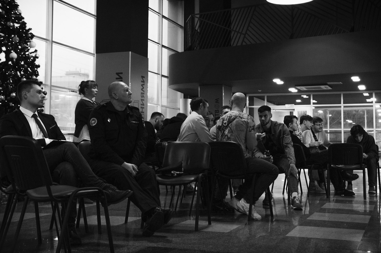 A group of people sitting around a christmas tree